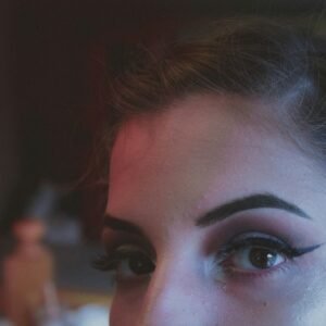 woman with brown hair and black eye shadow