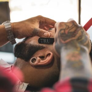 man in red shirt holding the head of a man
